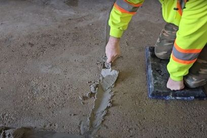 man repairing concrete crack